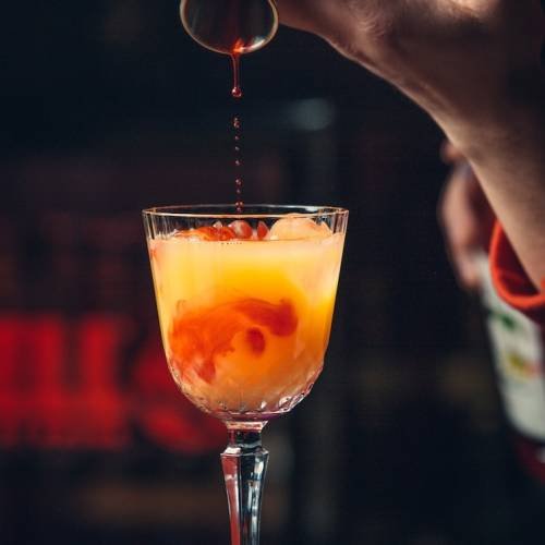 adding-red-syrup-into-orange-coc